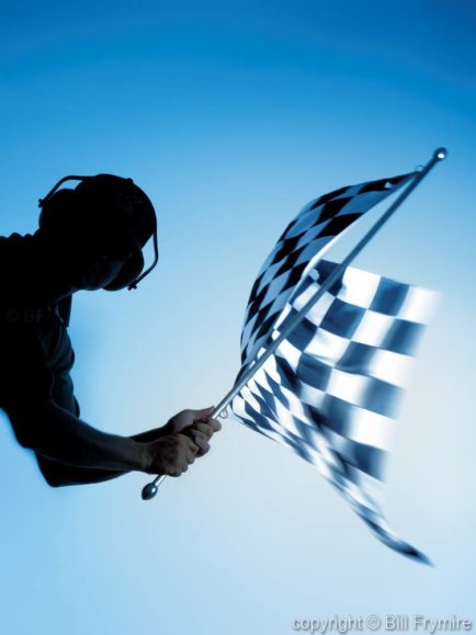 man waving checkered flag - model released